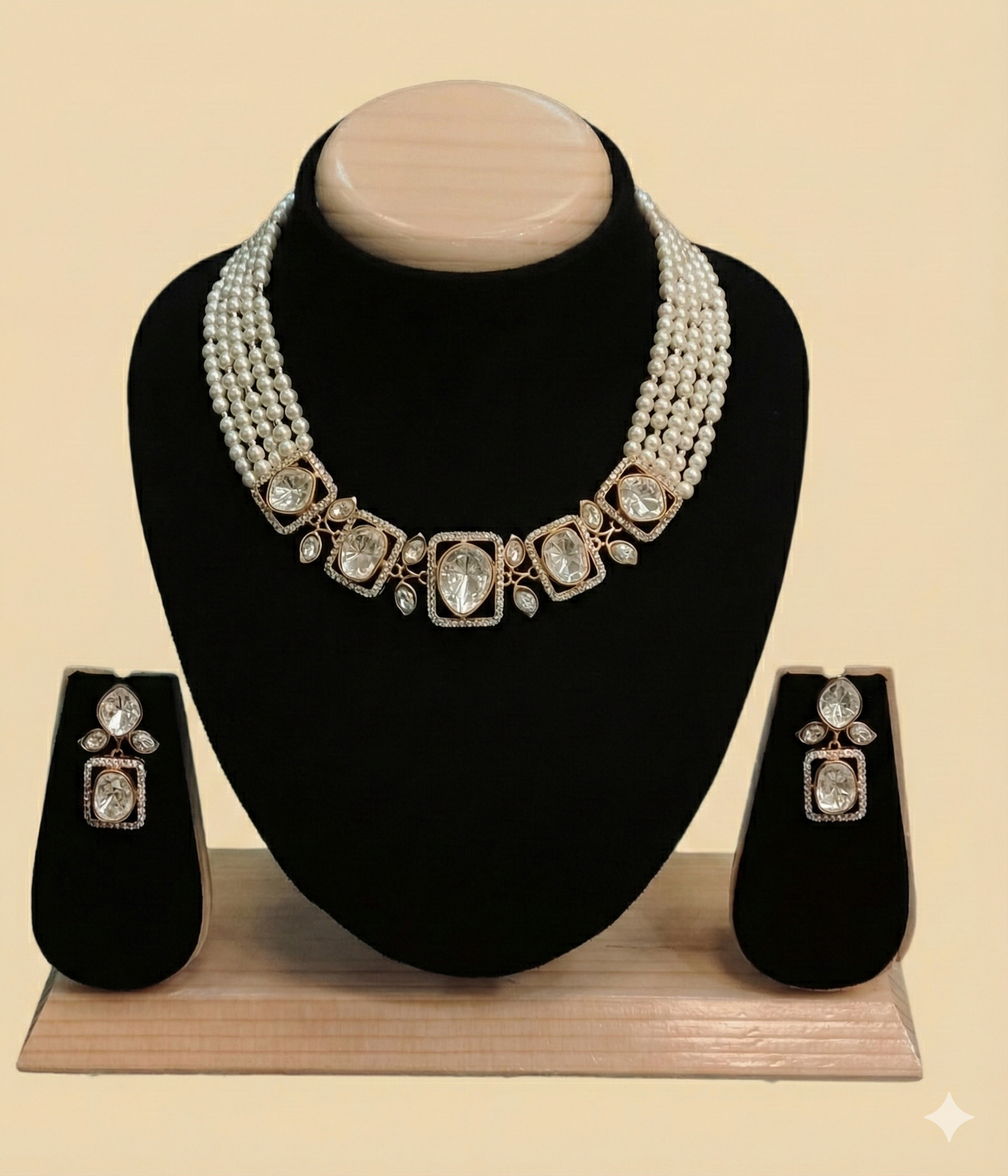 Multi-strand white pearl choker necklace featuring large square-cut crystal centerpieces with matching drop earrings on a black display bust.