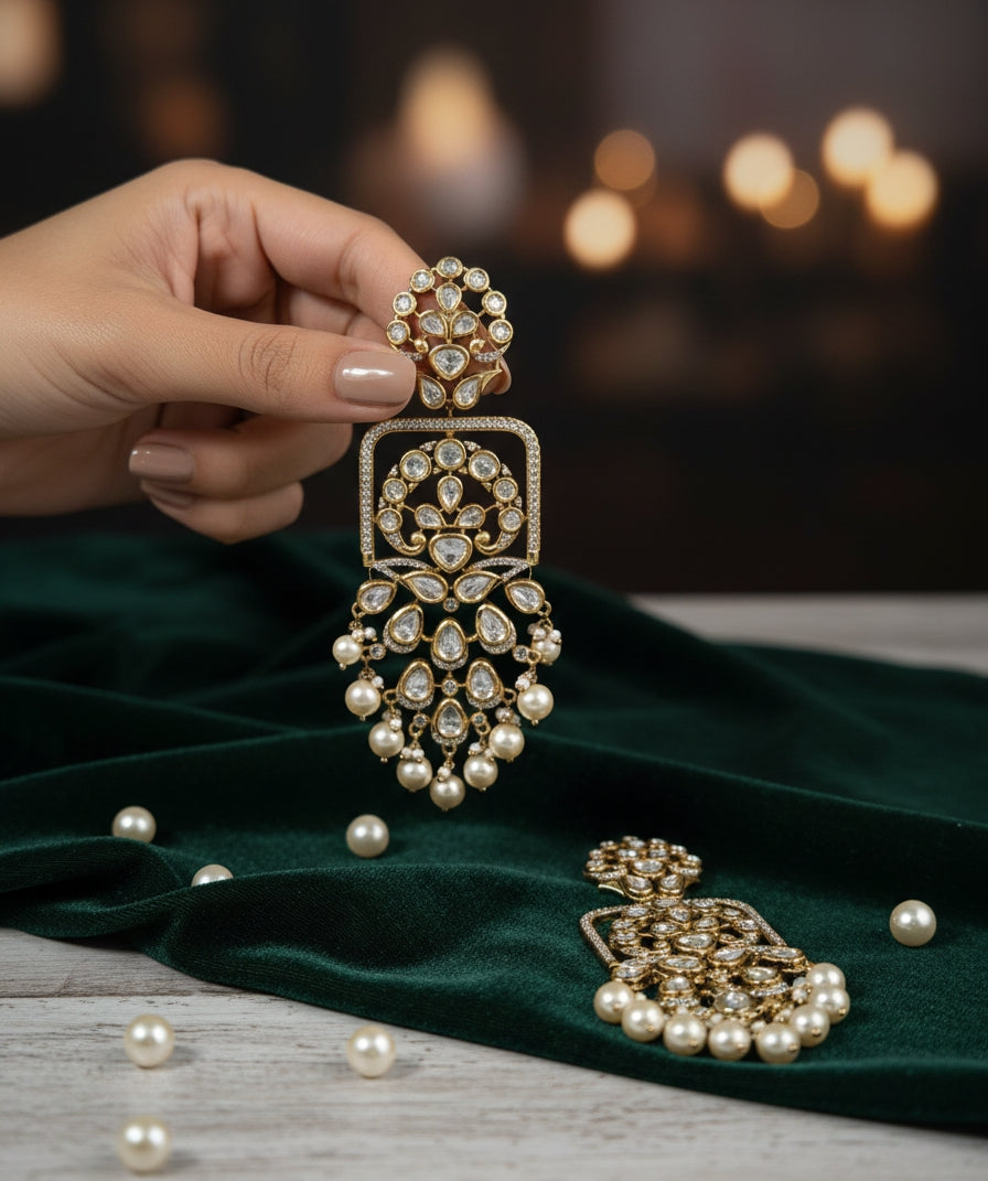 Detailed product shot of gold-plated Polki and Kundan drop earrings featuring a square frame and layered pearl bunches.