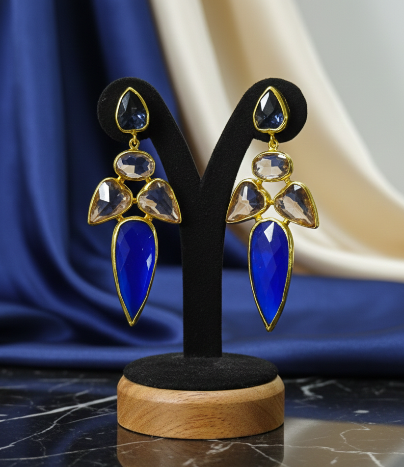Elegant royal blue and gold statement earrings with geometric cut stones suitable for evening wear.
